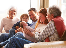 Extended family playing with a baby